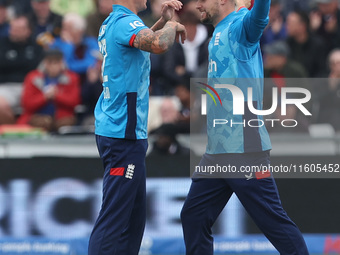 England's Brydon Carse celebrates with Will Jacks after having Australia's Mitchell Marsh caught behind the wicket in the Metro Bank One Day...