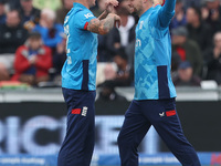 England's Brydon Carse celebrates with Will Jacks after having Australia's Mitchell Marsh caught behind the wicket in the Metro Bank One Day...