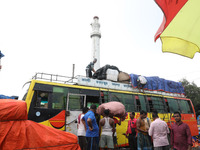 Labourers load consumer goods onto a passenger bus after it arrives from a neighboring state at a bus terminal in Kolkata, India, on Septemb...