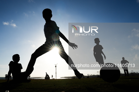 Kids play football at the Galle Face promenade in Colombo, Sri Lanka, on September 24, 2024. 