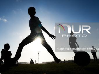 Kids play football at the Galle Face promenade in Colombo, Sri Lanka, on September 24, 2024. (