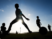 Kids play football at the Galle Face promenade in Colombo, Sri Lanka, on September 24, 2024. (