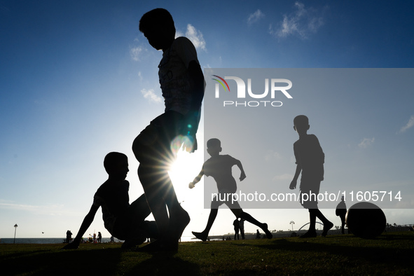 Kids play football at the Galle Face promenade in Colombo, Sri Lanka, on September 24, 2024. 