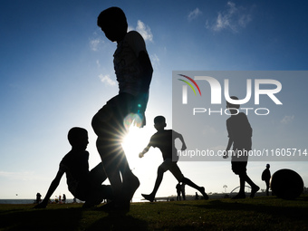 Kids play football at the Galle Face promenade in Colombo, Sri Lanka, on September 24, 2024. (