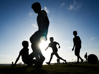 Kids play football at the Galle Face promenade in Colombo, Sri Lanka, on September 24, 2024. (