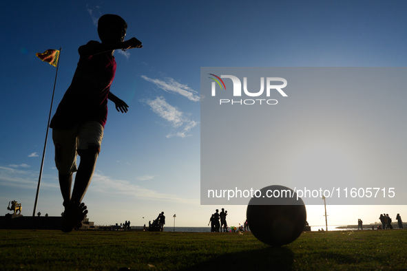 Kids play football at the Galle Face promenade in Colombo, Sri Lanka, on September 24, 2024. 