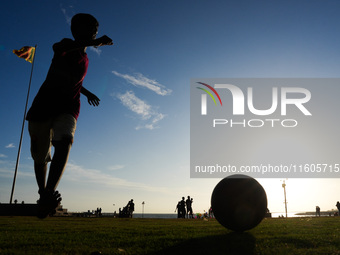 Kids play football at the Galle Face promenade in Colombo, Sri Lanka, on September 24, 2024. (