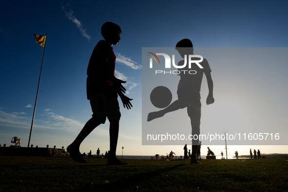 Kids play football at the Galle Face promenade in Colombo, Sri Lanka, on September 24, 2024. 