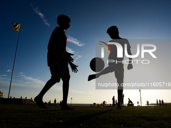 Kids play football at the Galle Face promenade in Colombo, Sri Lanka, on September 24, 2024. (