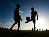 Kids play football at the Galle Face promenade in Colombo, Sri Lanka, on September 24, 2024. (