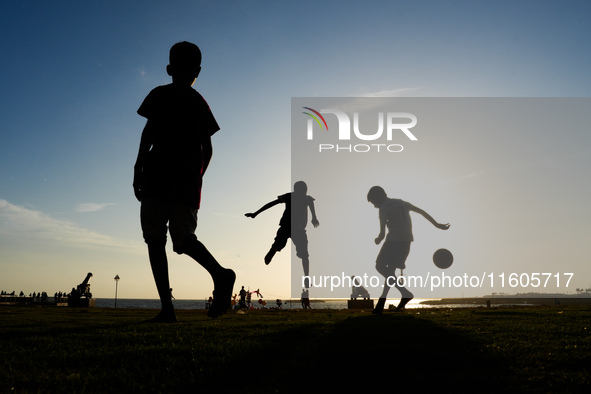 Kids play football at the Galle Face promenade in Colombo, Sri Lanka, on September 24, 2024. 