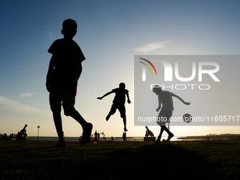 Kids play football at the Galle Face promenade in Colombo, Sri Lanka, on September 24, 2024. (