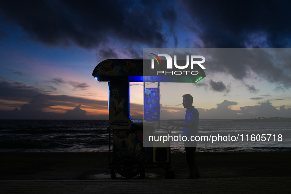 An ice cream vendor waits for customers in Colombo, Sri Lanka, on September 24, 2024. 