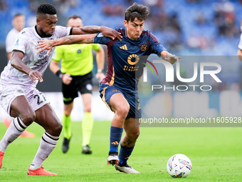 Christian Kabasele of Udinese Calcio and Paulo Dybala of AS Roma compete for the ball during the Serie A Enilive match between AS Roma and U...