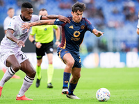 Christian Kabasele of Udinese Calcio and Paulo Dybala of AS Roma compete for the ball during the Serie A Enilive match between AS Roma and U...