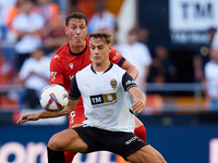 Dani Gomez (R) of Valencia CF competes for the ball with Herrando of CA Osasuna during the LaLiga EA Sports match between Valencia CF and CA...