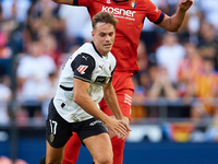 Dani Gomez (L) of Valencia CF competes for the ball with Herrando of CA Osasuna during the LaLiga EA Sports match between Valencia CF and CA...