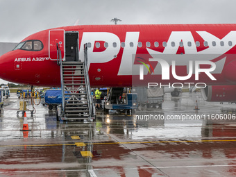 PLAY airline Airbus A321neo passenger aircraft spotted parked in front of the airport terminal building and the air bridge on the tarmac of...