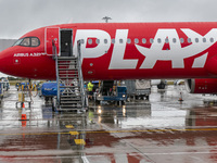 PLAY airline Airbus A321neo passenger aircraft spotted parked in front of the airport terminal building and the air bridge on the tarmac of...