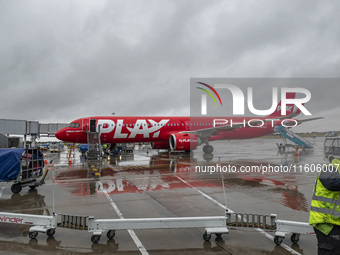 PLAY airline Airbus A321neo passenger aircraft spotted parked in front of the airport terminal building and the air bridge on the tarmac of...