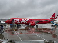 PLAY airline Airbus A321neo passenger aircraft spotted parked in front of the airport terminal building and the air bridge on the tarmac of...