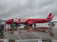 PLAY airline Airbus A321neo passenger aircraft spotted parked in front of the airport terminal building and the air bridge on the tarmac of...