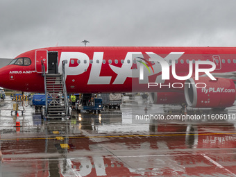 PLAY airline Airbus A321neo passenger aircraft spotted parked in front of the airport terminal building and the air bridge on the tarmac of...