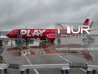 PLAY airline Airbus A321neo passenger aircraft spotted parked in front of the airport terminal building and the air bridge on the tarmac of...