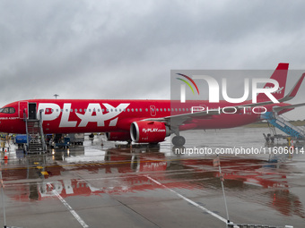 PLAY airline Airbus A321neo passenger aircraft spotted parked in front of the airport terminal building and the air bridge on the tarmac of...