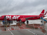 PLAY airline Airbus A321neo passenger aircraft spotted parked in front of the airport terminal building and the air bridge on the tarmac of...