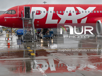 PLAY airline Airbus A321neo passenger aircraft spotted parked in front of the airport terminal building and the air bridge on the tarmac of...