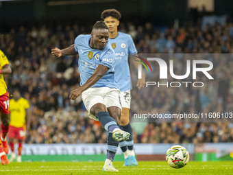 Jeremy Doku #11 of Manchester City F.C. scores a goal during the Carabao Cup Third Round match between Manchester City and Watford at the Et...