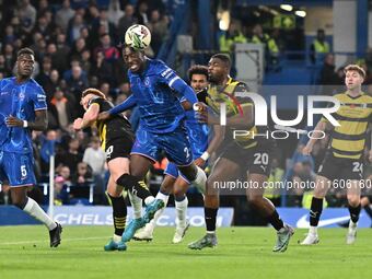 Axel Disasi (2 Chelsea) is challenged by Emile Acquah (20 Barrow) during the Carabao Cup Third Round match between Chelsea and Barrow at Sta...