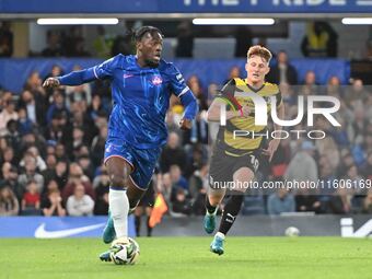 Mykhailo Mudryk (10 Chelsea) is chased by Gerard Garner (10 Barrow) during the Carabao Cup Third Round match between Chelsea and Barrow at S...