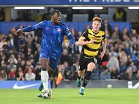 Mykhailo Mudryk (10 Chelsea) is chased by Gerard Garner (10 Barrow) during the Carabao Cup Third Round match between Chelsea and Barrow at S...