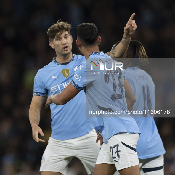 Matheus Nunes #27 of Manchester City F.C. celebrates his goal with John Stones #5 of Manchester City F.C. during the Carabao Cup Third Round...