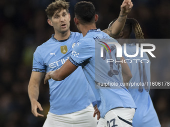 Matheus Nunes #27 of Manchester City F.C. celebrates his goal with John Stones #5 of Manchester City F.C. during the Carabao Cup Third Round...