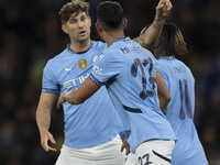 Matheus Nunes #27 of Manchester City F.C. celebrates his goal with John Stones #5 of Manchester City F.C. during the Carabao Cup Third Round...