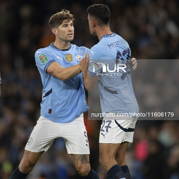 Matheus Nunes #27 of Manchester City F.C. celebrates his goal with John Stones #5 of Manchester City F.C. during the Carabao Cup Third Round...