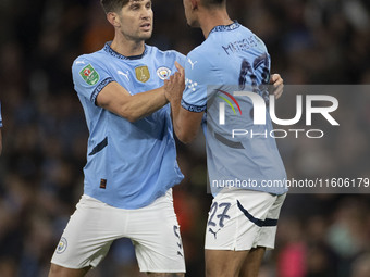 Matheus Nunes #27 of Manchester City F.C. celebrates his goal with John Stones #5 of Manchester City F.C. during the Carabao Cup Third Round...