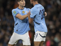 Matheus Nunes #27 of Manchester City F.C. celebrates his goal with John Stones #5 of Manchester City F.C. during the Carabao Cup Third Round...