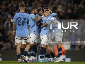 Matheus Nunes #27 of Manchester City F.C. celebrates his goal with teammates during the Carabao Cup Third Round match between Manchester Cit...