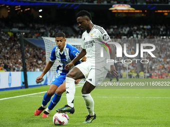 Vinicius Junior left winger of Real Madrid and Brazil and Santiago Mouriño centre-back of Alaves and Uruguay compete for the ball during the...