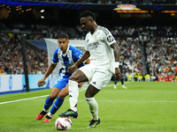 Vinicius Junior left winger of Real Madrid and Brazil and Santiago Mouriño centre-back of Alaves and Uruguay compete for the ball during the...