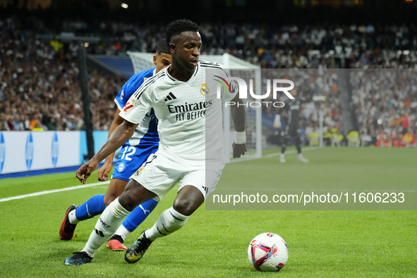 Vinicius Junior left winger of Real Madrid and Brazil and Santiago Mouriño centre-back of Alaves and Uruguay compete for the ball during the...