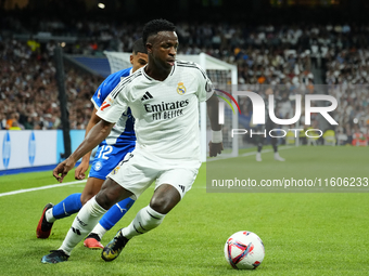 Vinicius Junior left winger of Real Madrid and Brazil and Santiago Mouriño centre-back of Alaves and Uruguay compete for the ball during the...