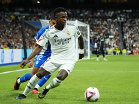 Vinicius Junior left winger of Real Madrid and Brazil and Santiago Mouriño centre-back of Alaves and Uruguay compete for the ball during the...