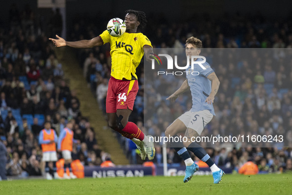 Kwadwo Baah #34 of Watford F.C. chests the ball during the Carabao Cup Third Round match between Manchester City and Watford at the Etihad S...