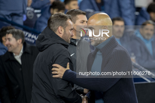 Manchester City F.C. manager Pep Guardiola and Watford F.C. manager Tom Cleverley shake hands during the Carabao Cup Third Round match betwe...