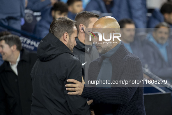 Manchester City F.C. manager Pep Guardiola and Watford F.C. manager Tom Cleverley shake hands during the Carabao Cup Third Round match betwe...